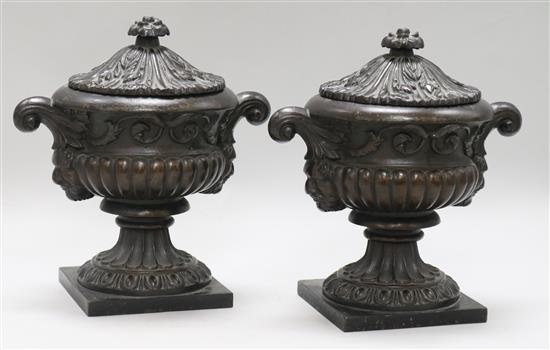 A pair of small iron urns